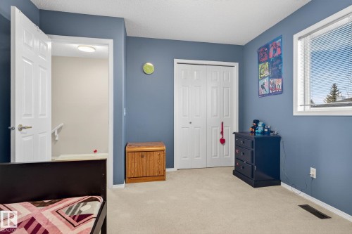 Carpeted room with a double-door closet, a single window with blinds, and painted walls - 3912 31 Street, Edmonton, AB 