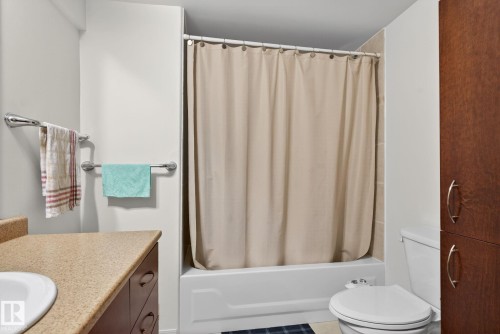 Bathroom featuring a full tub and shower combination with light-toned wall tile surround - 3912 31 Street, Edmonton, AB 