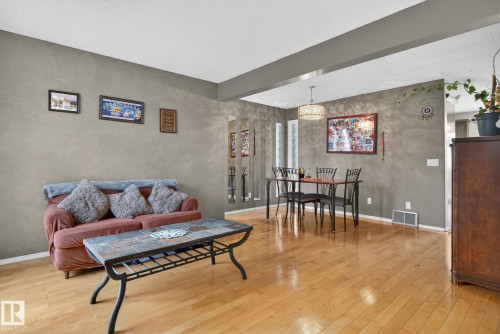 Open-concept living and dining area featuring wood-finish flooring - 3912 31 Street, Edmonton, AB 