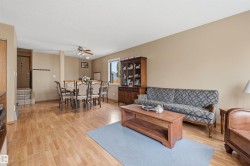 Open-concept living and dining areas featuring wood-finish flooring, neutral wall tones, and recessed lighting - 