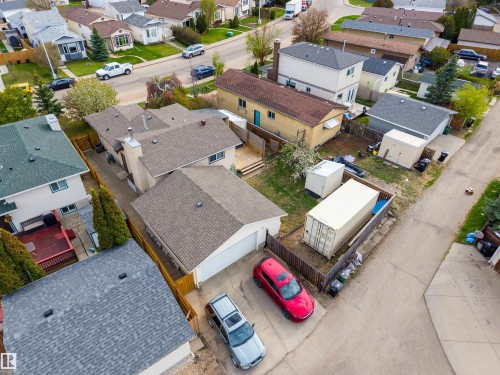 Residential property featuring an attached garage, a driveway with concrete paving, and a fenced backyard - 18648 57 Avenue, Edmonton, AB - Outdoor With View