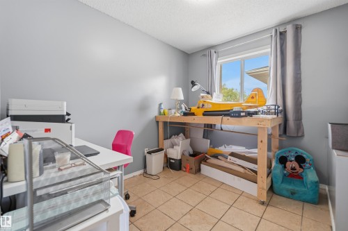 Room featuring a window with gray drapes, neutral wall paint, and square floor tiles - 18648 57 Avenue, Edmonton, AB - Indoor