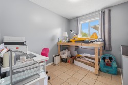Room featuring a window with gray drapes, neutral wall paint, and square floor tiles - 