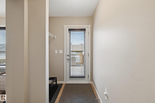 Full-light door with integrated blinds, providing natural illumination and privacy - 3457 Cutler Crescent, Edmonton, AB - Indoor Photo Showing Other Room
