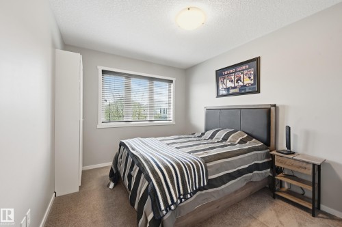 Bedroom featuring a neutral color palette, a single window with blinds, and a flush-mount ceiling light - 3457 Cutler Crescent, Edmonton, AB - Indoor Photo Showing Bedroom