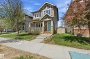 Two-story residential architecture featuring horizontal siding, decorative shake siding accents, and a covered front porch with white railings - 3457 Cutler Crescent, Edmonton, AB  - Outdoor With Deck Patio Veranda With Facade 