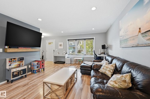 Open-concept living space featuring recessed lighting and wood-finish flooring - 3457 Cutler Crescent, Edmonton, AB - Indoor Photo Showing Living Room