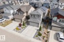 Contemporary two-story home featuring a grey exterior with white trim, an attached two-car garage, and solar panels on the roof - 22931 96 Avenue, Edmonton, AB  - Outdoor With Facade 