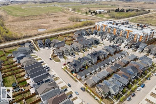 Aerial perspective showcasing a residential development with detached homes and a multi-story apartment complex - 22931 96 Avenue, Edmonton, AB - Outdoor With View