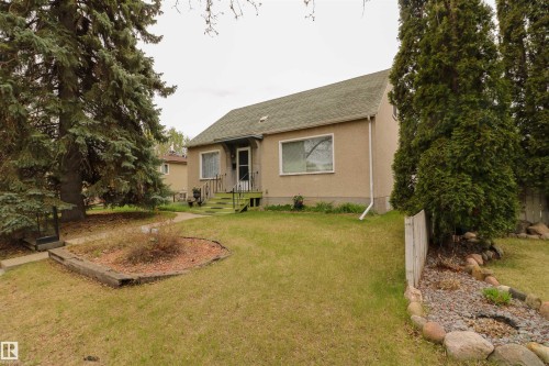 Property exterior featuring a stucco finish and a green shingle roof - 11614 70 Street, Edmonton, AB - Outdoor