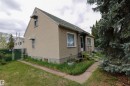 Exterior featuring stucco siding, green shingled roof, and an inviting front entry with a small stoop - 11614 70 Street, Edmonton, AB  - Outdoor 
