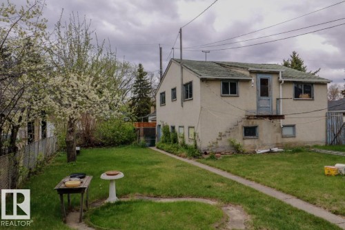 Spacious rear yard featuring an established flowering tree and mature perimeter foliage - 11614 70 Street, Edmonton, AB - Outdoor