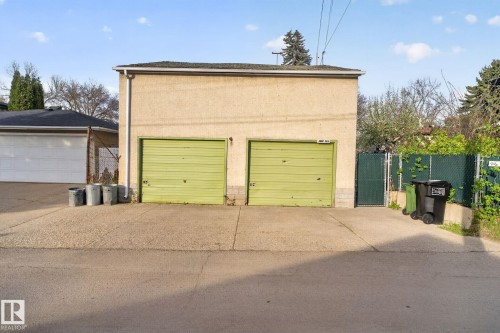 Two-car detached garage with stucco exterior and two green overhead doors - 11614 70 Street, Edmonton, AB 