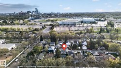Aerial perspective showcasing a residential neighborhood with a distant cityscape - 