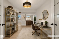 Dedicated office space featuring light wood-finish flooring and a neutral area rug - 
