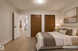 Bedroom featuring wood-finish flooring, two wood-paneled closet doors, and recessed ceiling lighting - 