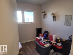 Light-filled room featuring a double window, wood-finish flooring, and white baseboards - 