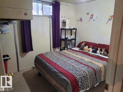 Room featuring light-colored walls and a window with purple drapes - 11616 152 Avenue, Edmonton, AB - Indoor Photo Showing Bedroom