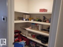 Pantry featuring multiple levels of built-in shelving, providing extensive storage - 
