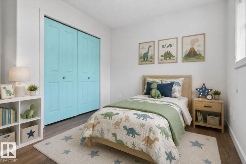 White walls complement wood-finish flooring - 11 450 Mcconachie Way, Edmonton, AB - Indoor Photo Showing Bedroom
