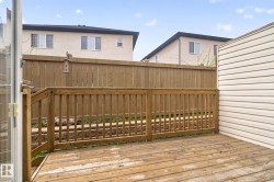 Wood deck with a slatted railing, providing an outdoor extension - 