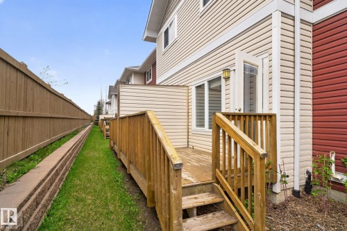 Rear wooden deck with stairs providing outdoor access - 11 450 Mcconachie Way, Edmonton, AB - Outdoor With Exterior