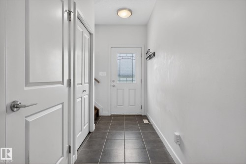 Entryway featuring durable dark tile flooring - 11 450 Mcconachie Way, Edmonton, AB - Indoor Photo Showing Other Room