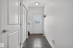 Entryway featuring durable dark tile flooring - 