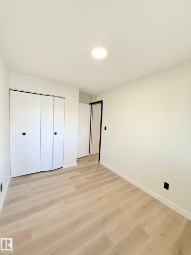 Interior room featuring light wood-finish flooring - 11628 151 Avenue Nw, Edmonton, AB 