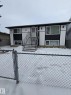 Split-level exterior featuring a black and white facade with vertical siding accents - 11927 85 Street Nw, Edmonton, AB  - Outdoor 