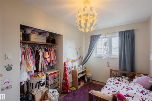 White walls and wood-finish flooring provide a neutral base - 5931 138 Avenue, Edmonton, AB - Indoor Photo Showing Bedroom