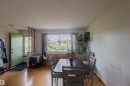 Open concept room featuring wood-finish flooring, a prominent window with a deep sill, and a light-colored entry door - 5931 138 Avenue, Edmonton, AB  - Indoor Photo Showing Dining Room 
