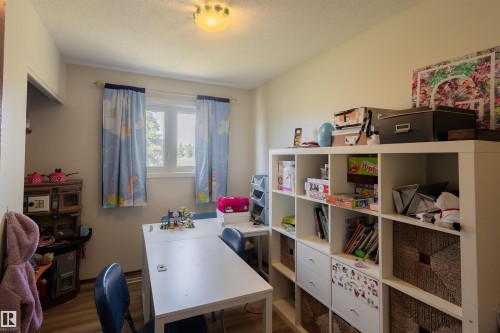 Recessed window with white trim, wood-finish flooring, and a flush-mount ceiling fixture - 5931 138 Avenue, Edmonton, AB - Indoor Photo Showing Office