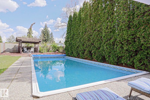 In-ground swimming pool featuring a blue liner and perimeter tile - 1214 85 Street Nw, Edmonton, AB - Outdoor With In Ground Pool With Backyard