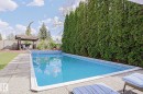 In-ground swimming pool featuring a blue liner and perimeter tile - 1214 85 Street Nw, Edmonton, AB  - Outdoor With In Ground Pool With Backyard 