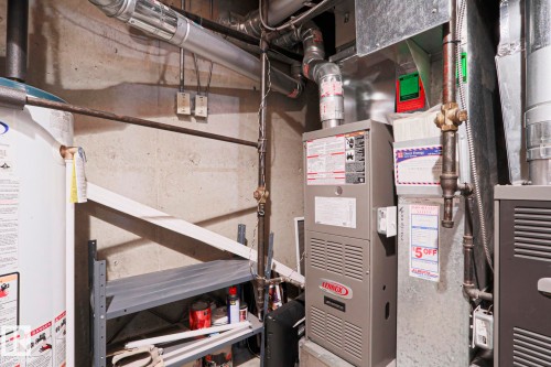 Utility room featuring a water heater, Lennox furnace, and additional heating/cooling units - 1214 85 Street Nw, Edmonton, AB - Indoor Photo Showing Basement