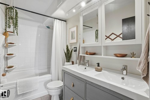 Bathroom featuring a dual vanity with undermount sinks, gray cabinetry, and white countertops - 4 Langley Dr, Fort Saskatchewan, AB - Indoor Photo Showing Bathroom