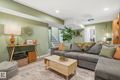 Recessed lighting illuminates this living space featuring a textured area rug and a light wood-finish coffee table - 4 Langley Dr, Fort Saskatchewan, AB - Indoor Photo Showing Living Room