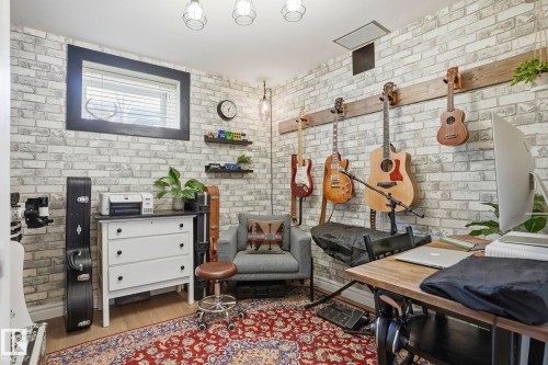 Interior space featuring white-washed brick-style walls - 4 Langley Dr, Fort Saskatchewan, AB -  Photo Showing Other Room