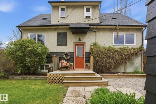 Rear exterior featuring a red entry door and multi-level wood deck - 4 Langley Dr, Fort Saskatchewan, AB - Outdoor