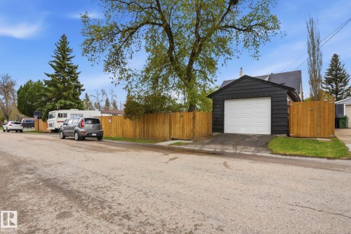 Detached garage featuring black siding and a white panel door - 4 Langley Dr, Fort Saskatchewan, AB - Outdoor