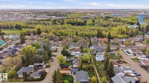Aerial perspective showcasing a residential area with mature trees and a substantial green space - 4 Langley Dr, Fort Saskatchewan, AB - Outdoor With View