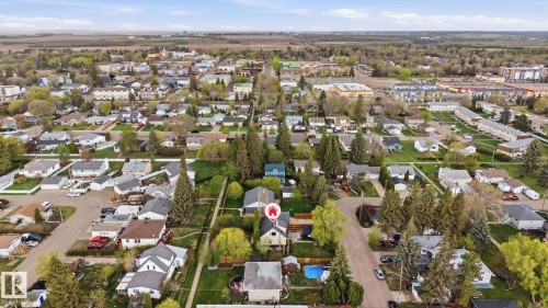 Residential neighborhood featuring single-family homes, mature trees, and paved streets - 4 Langley Dr, Fort Saskatchewan, AB - Outdoor With View