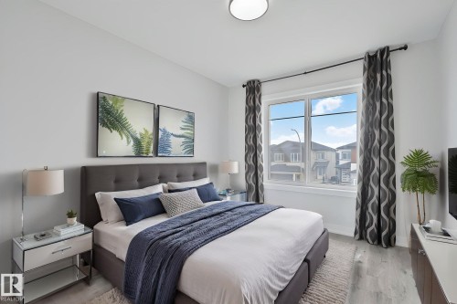 Window with double-pane glass, light grey walls, and wood-finish flooring - 334 Aston Close, Leduc, AB - Indoor Photo Showing Bedroom