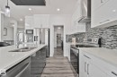 Contemporary kitchen featuring light quartz countertops and wood-finish flooring - 334 Aston Close, Leduc, AB  - Indoor Photo Showing Kitchen With Double Sink With Upgraded Kitchen 