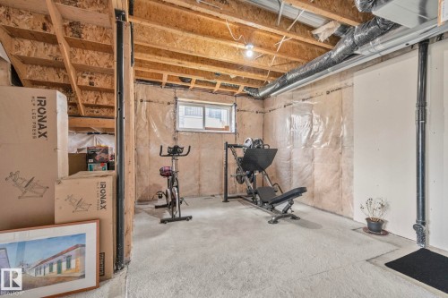 Unfinished basement featuring exposed joists, a concrete floor, an egress window, and visible insulation - 334 Aston Close, Leduc, AB - Indoor Photo Showing Basement