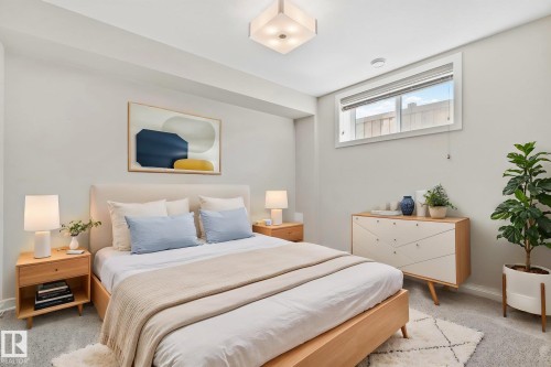 Bedroom featuring light gray walls, plush gray carpeting, and a modern flush-mount ceiling light. Virtually staged. - 67 Enchanted Way N, St. Albert, AB - Indoor Photo Showing Bedroom