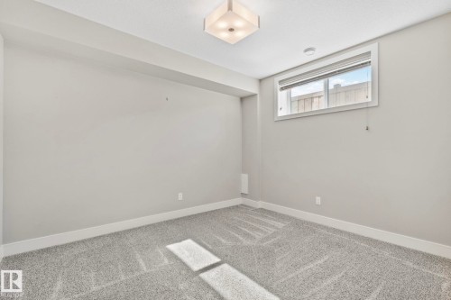 Room featuring neutral wall tones, gray carpeting, and white baseboards - 67 Enchanted Way N, St. Albert, AB - Indoor Photo Showing Other Room