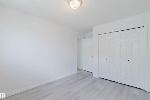 Room featuring light wood-finish flooring, white walls, and a ceiling-mounted light fixture - 13755 131B Avenue, Edmonton, AB - Indoor
