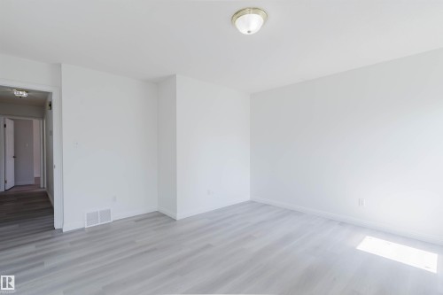 Room featuring light wood-finish flooring and crisp white walls - 13755 131B Avenue, Edmonton, AB - Indoor Photo Showing Other Room